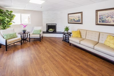A cozy interior common area with seating and plants