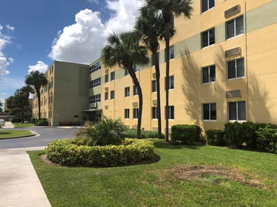 Exterior view of a senior living facility with landscaping