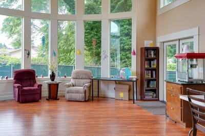 Bright common area with large windows and seating