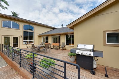 Outdoor patio area with seating and a grill