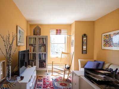Cozy living area with a rocking chair and bookshelves