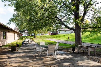 Outdoor patio area with seating and greenery