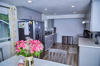 Bright kitchen with modern appliances and flowers on the table