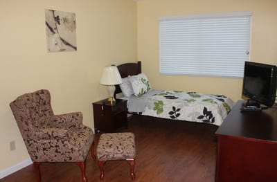 Private resident room with a bed and seating area