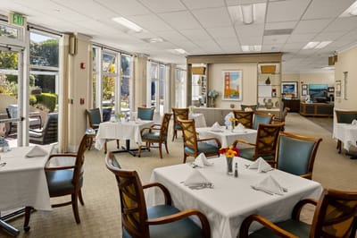 Bright dining area with tables set for guests