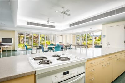 Bright common area with kitchen and outdoor views