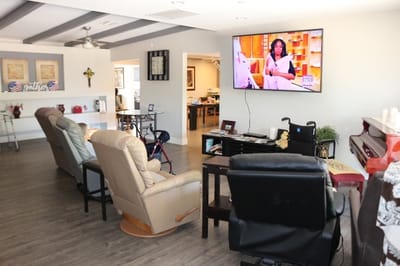 Interior of a common area with chairs and a TV