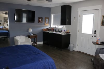Cozy resident room with a blue bed and modern decor