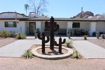 Front view of a senior living facility with cacti landscaping