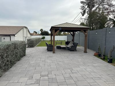 Outdoor gazebo area with seating and landscaping