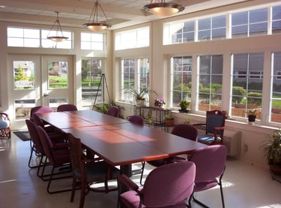 Bright common area with large windows and seating