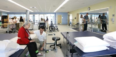 Therapist assisting a resident in a rehabilitation room