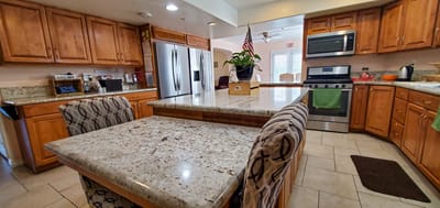 Bright kitchen area with wooden cabinets and granite countertops