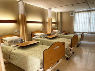 Interior view of resident bedrooms with hospital beds