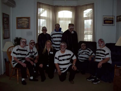 Residents and staff in costumes in a common area