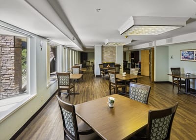 Bright dining room with large windows and wooden tables