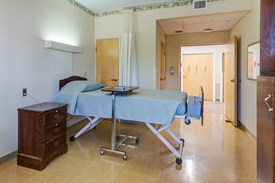 A private resident room with a bed and furniture