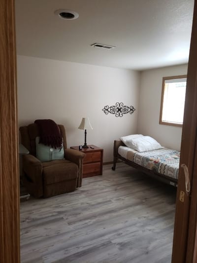 Cozy resident room with bed and chair