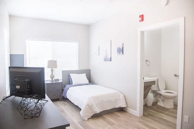 Cozy private resident room with a bed and desk