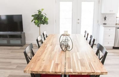 Large dining table set for residents in a bright space