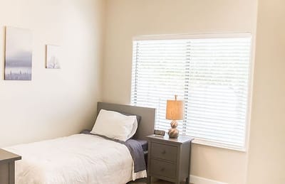 Cozy private room with natural light and simple decor