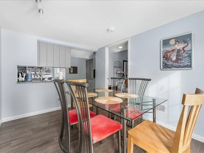 Bright dining area with a glass table and chairs