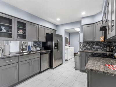 Modern kitchen interior with gray cabinets and appliances