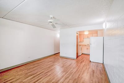 A bright, empty apartment interior with kitchen