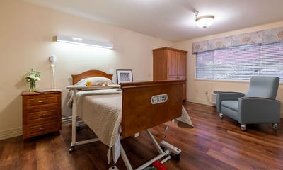 Cozy resident room with bed and armchair