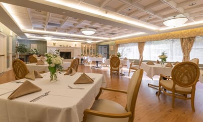Elegant dining room with neatly set tables and decorative flowers