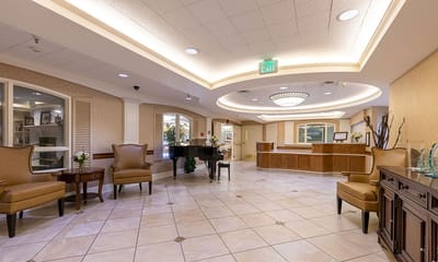 Bright lobby area with seating and a piano