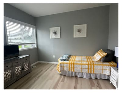 Brightly lit resident room with a bed and decor