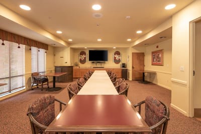 Bright common area with tables and chairs set up
