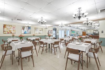 Dining area with tables set for residents