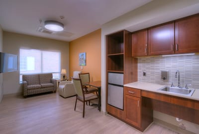 Cozy resident room with a kitchenette and seating area