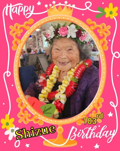 A resident celebrating her 103rd birthday with flowers