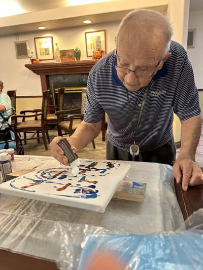 Resident painting during an activity session