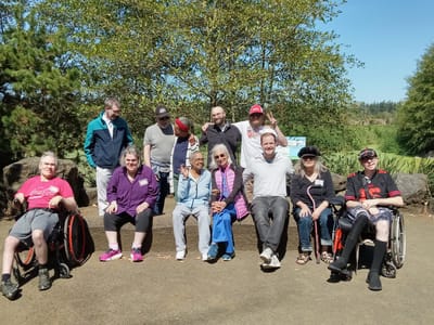Residents and staff enjoying time outdoors in a garden