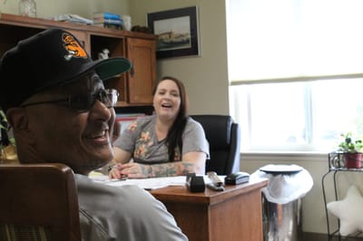 Two staff members interacting in an office setting