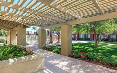 Outdoor space with landscaped gardens and covered seating
