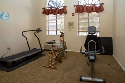 Interior view of a small fitness room with exercise equipment
