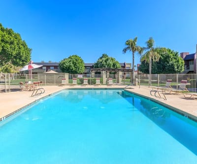 Outdoor swimming pool surrounded by lounge chairs