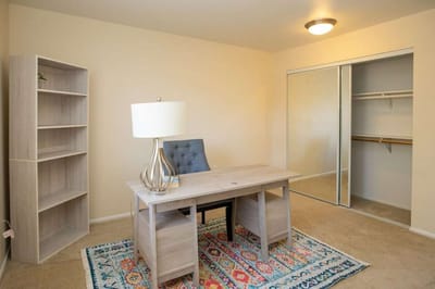Brightly lit interior of a resident's room with a desk