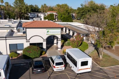 Aerial view of Elmwood Senior Living entrance and parking area
