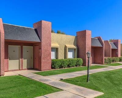 Exterior view of Eastridge Apartments with sunny landscaping