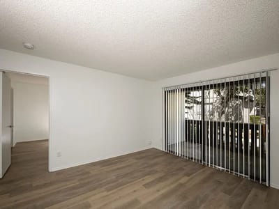 Bright interior space with large window and wood flooring