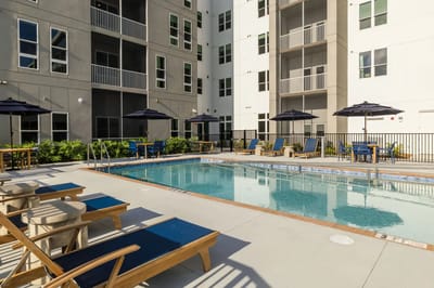 Outdoor pool area with lounge chairs and umbrellas