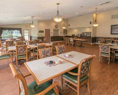 Dining area with tables and chairs set for residents