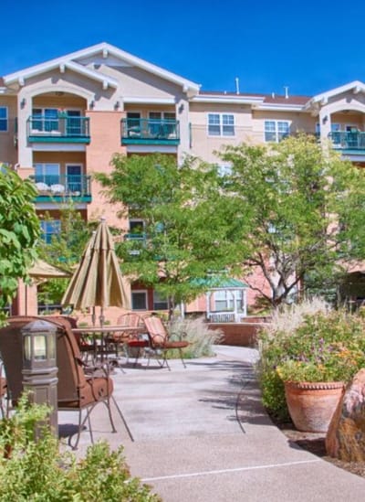Outdoor patio area with seating and greenery