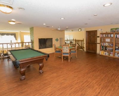 Bright common area with a pool table and seating